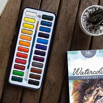 MozArt Supplies Watercolor Paint Essentials Set - Lightweight and Portable Metal Box - Lid Has 3 Partitions for Color Mixing - Easy-to-Blend Non-Toxic Formulation - 24 Vibrant Colors with Paintbrush